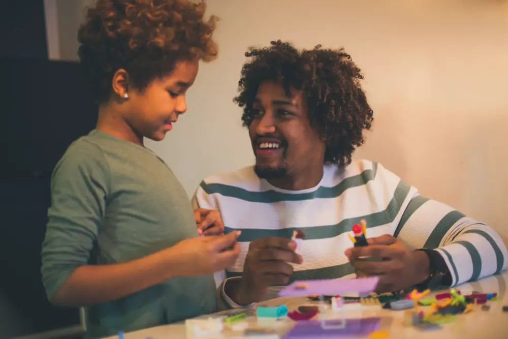 Father and son building some LEGOs together.