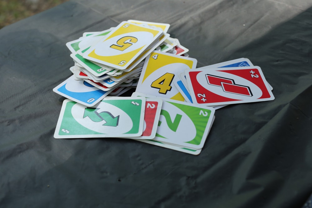 Closeup of Uno cards on a table.