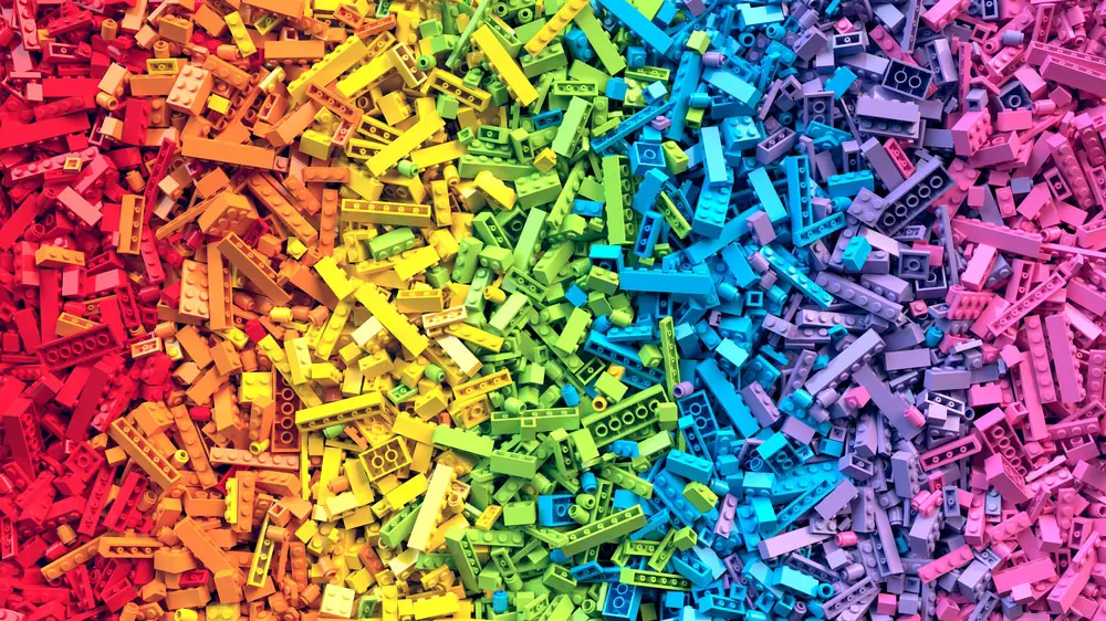 Closeup of a lot of LEGO pieces arranged by color.