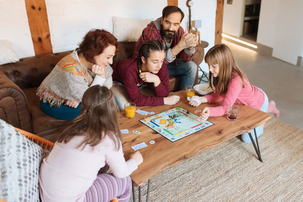 Family playing board games on a table.