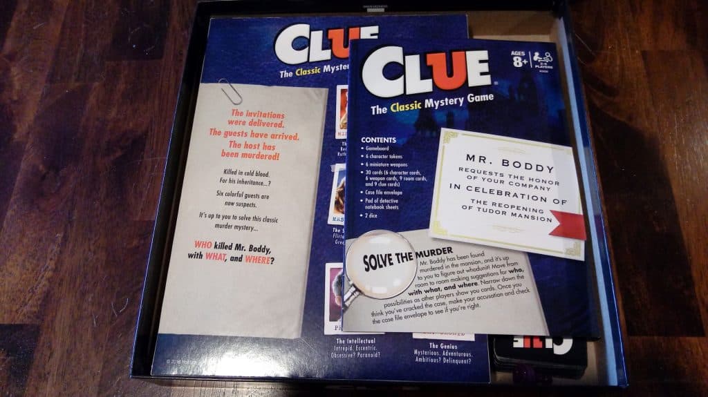 Closeup of the Clue game box opened and also the front of the rules.