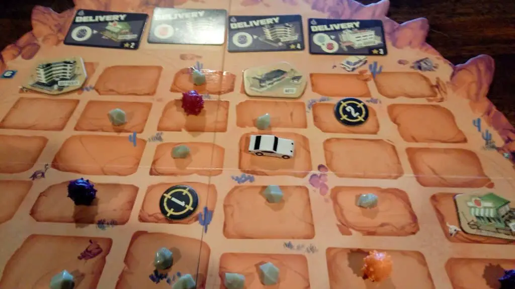 Closeup of the top of the Terror Below game board, which shows the bounty cards and some other components.