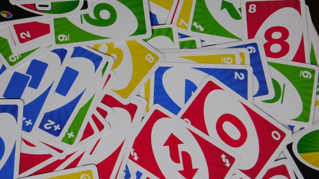 A closeup of some Uno cards scattered on a table.