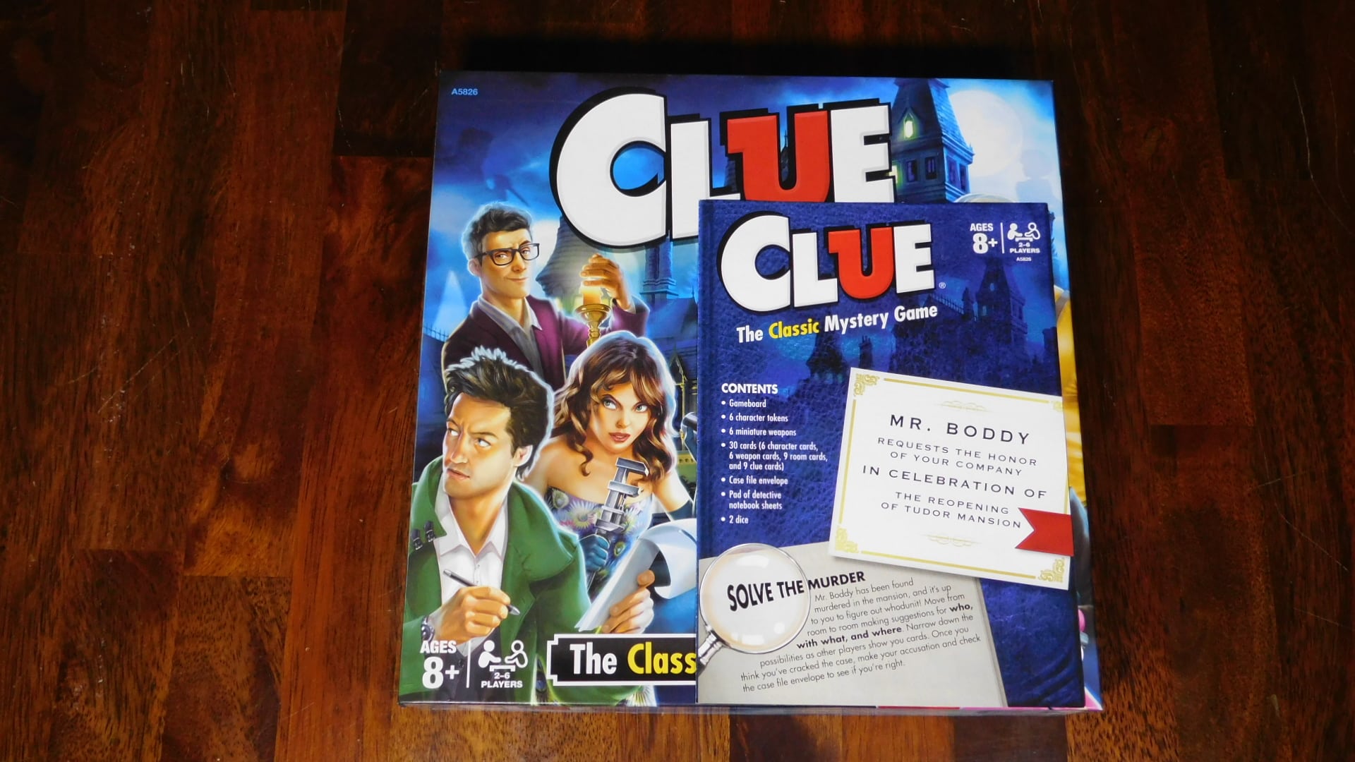 A closeup of Clue with the rulebook on the box cover.