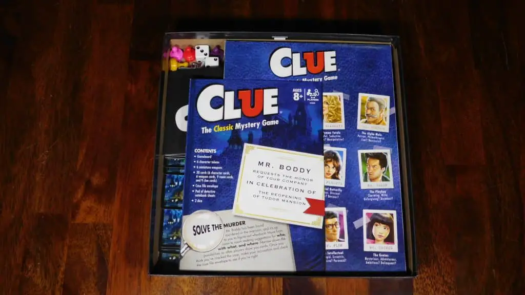 A closeup of an open box of Clue with the rulebook showing.