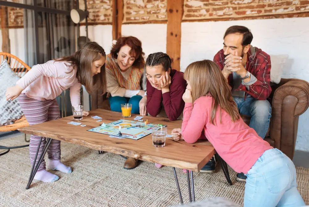 A family playing a game of Monopoly together.