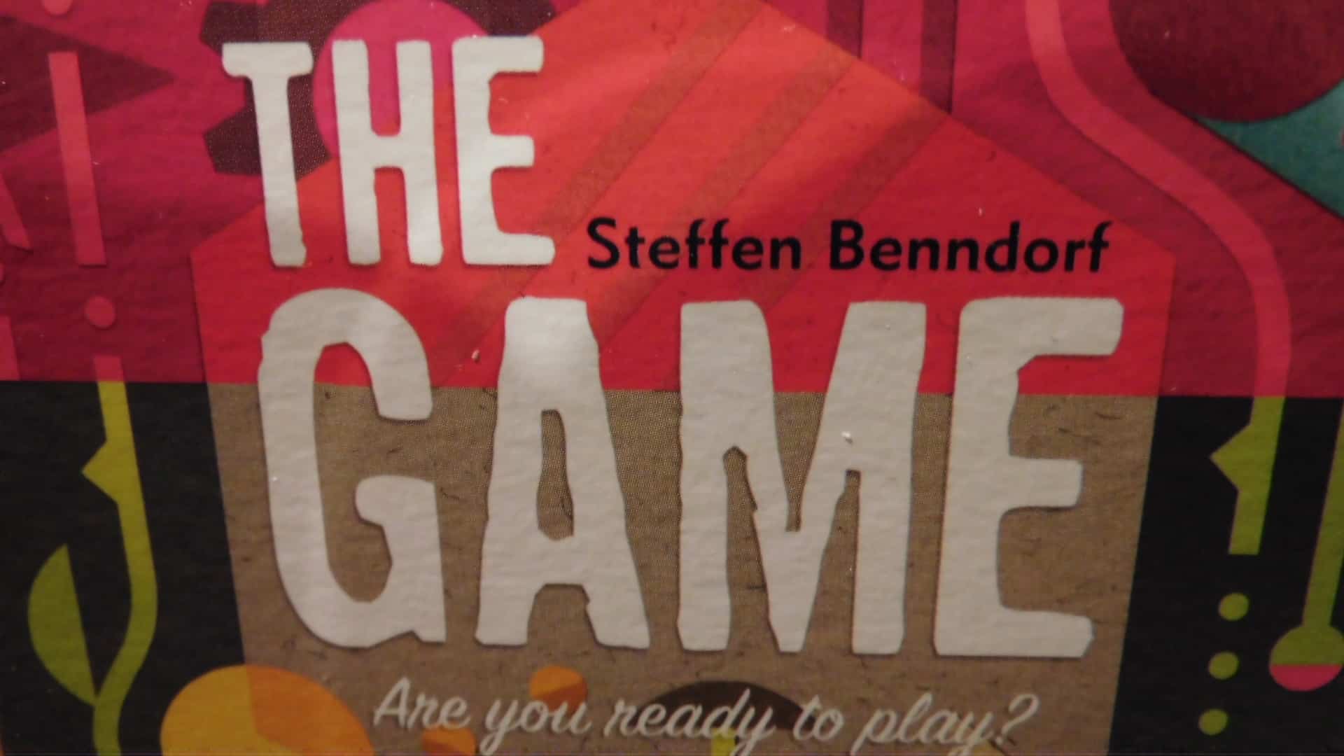 A closeup of the title of the front cover of the box for The Game.