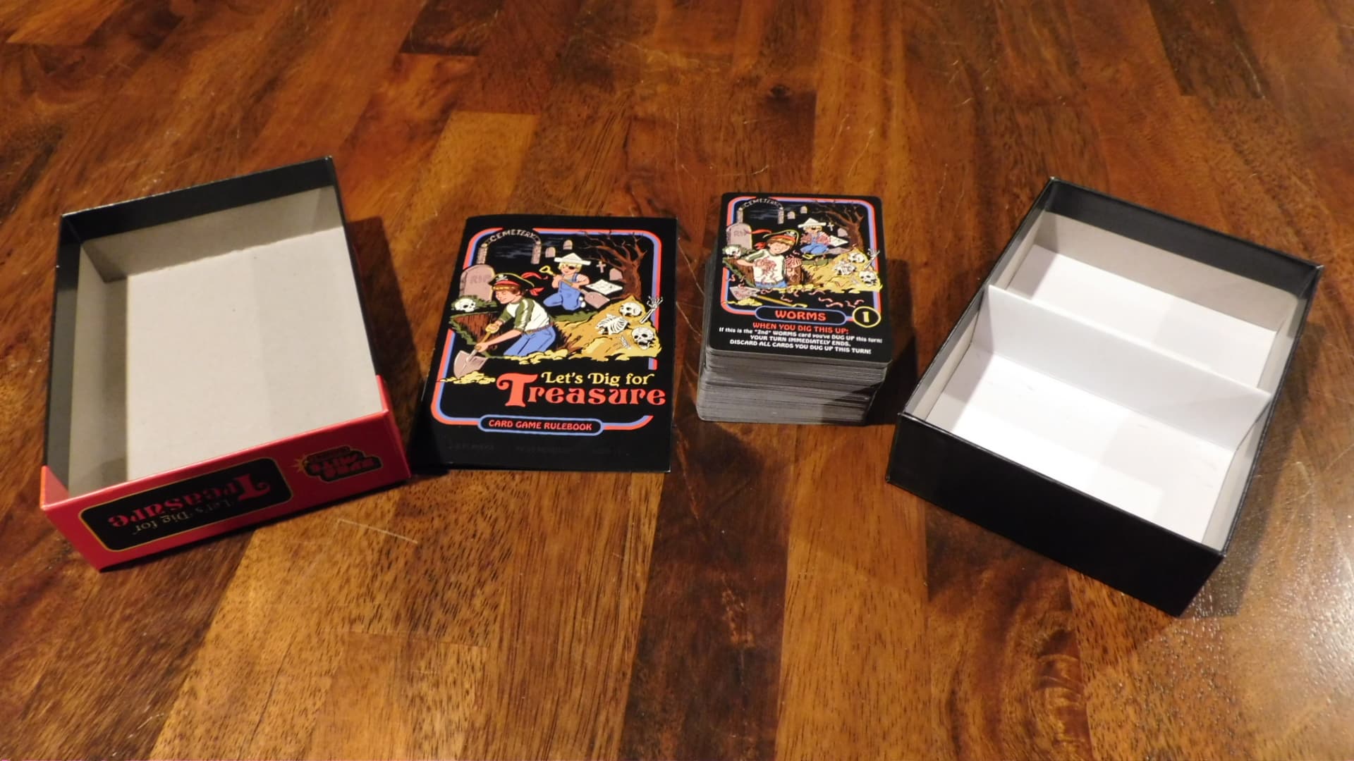 An open box with the components of Let's Dig For Treasure.