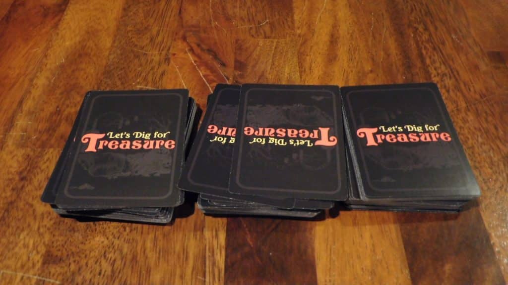 Three stacks of Let's Dig For Treasure cards, showing setup of the game.