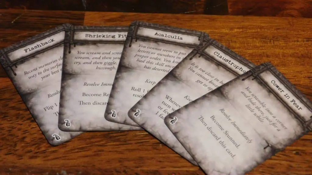 A closeup of Mansions Of Madness 2nd Edition insanity cards.