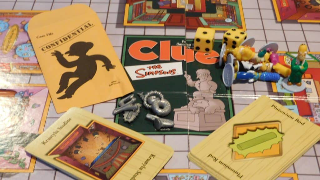 A closeup of the game board and components for Simpsons Clue 2nd Edition.