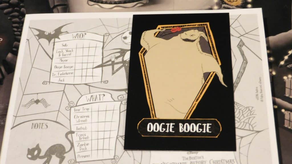 Clue: Tim Burton's Nightmare Before Christmas closeup showing the Oogie Boogie rumor card and the character sheet beneath it.