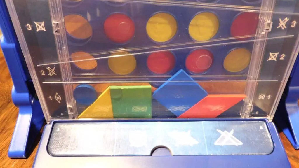 A game of Drop It in progress, and the game is sitting in front of a game of Connect 4 in progress.