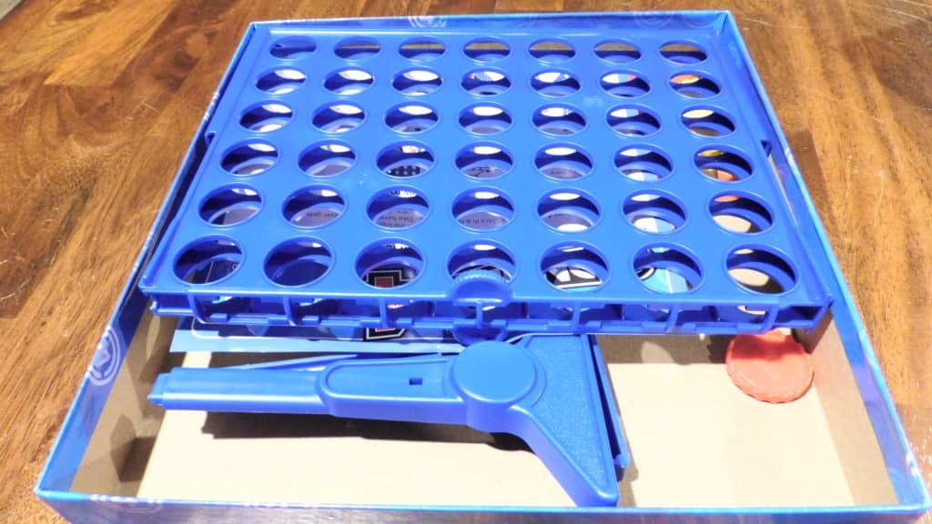An open box of Connect 4 showings its components.