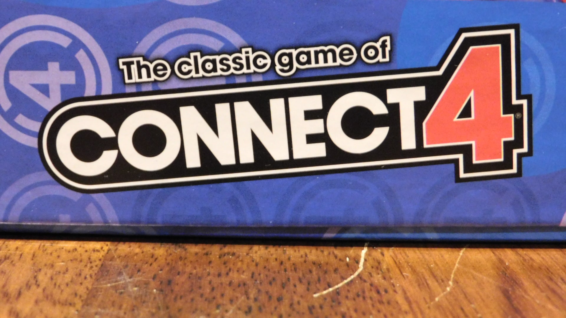A closeup of the part of the Connect 4 box that says those words.
