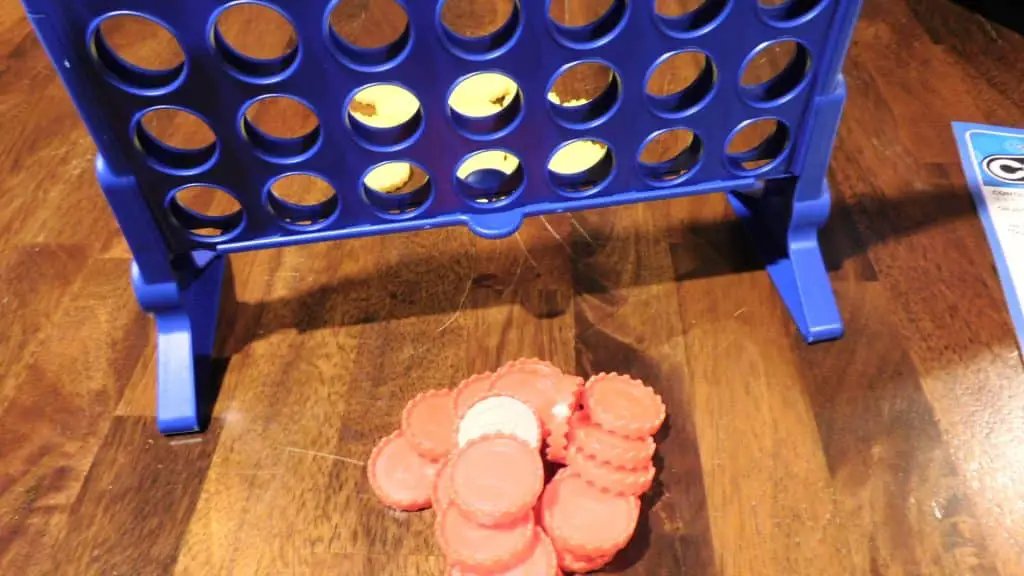 The Connect 4 grid and the red and yellow discs separated.