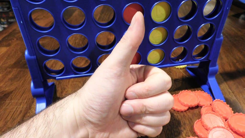 A hand giving Connect 4 the thumbs up.