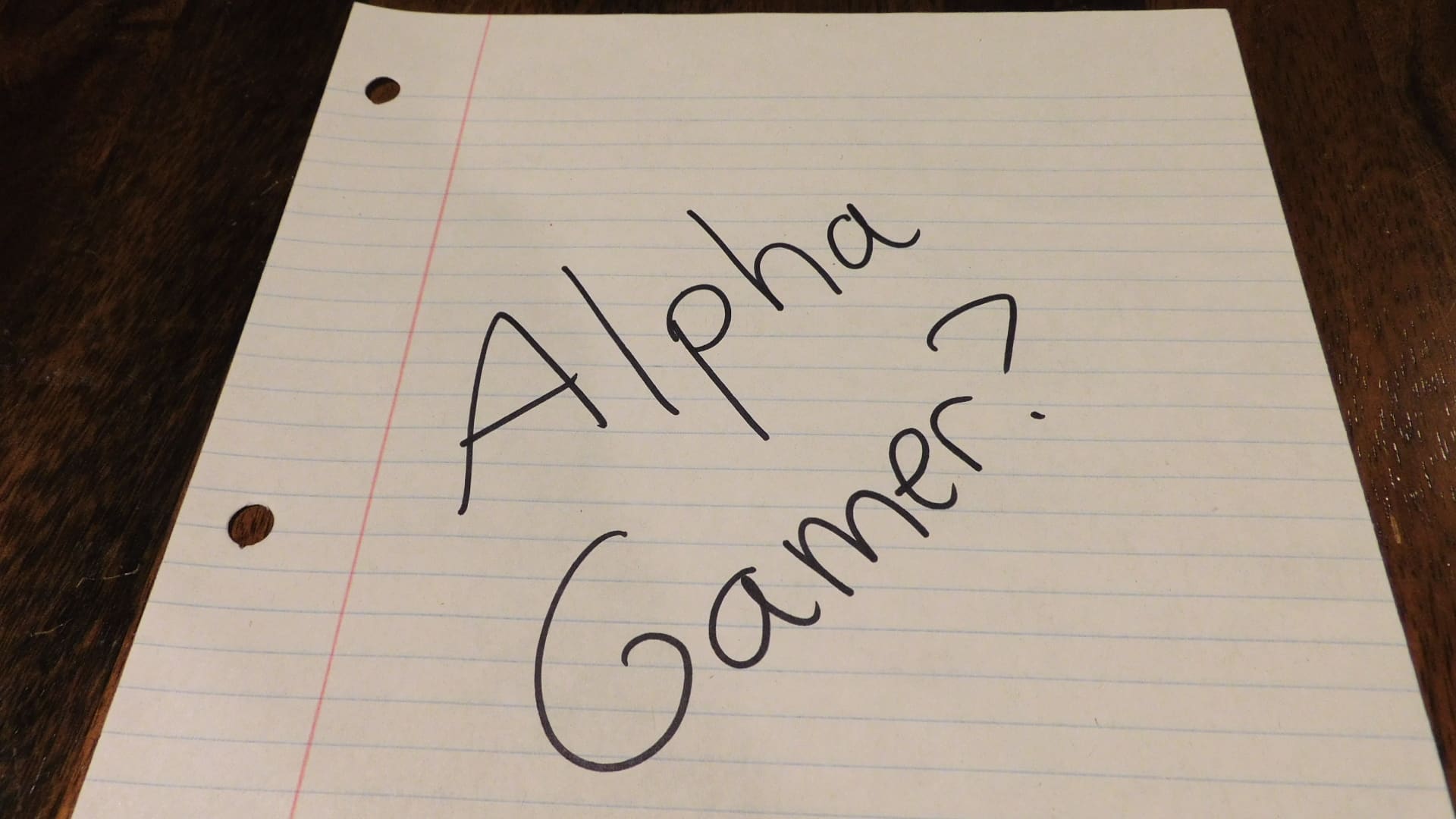 A piece of paper that says, "Alpha Gamer?"