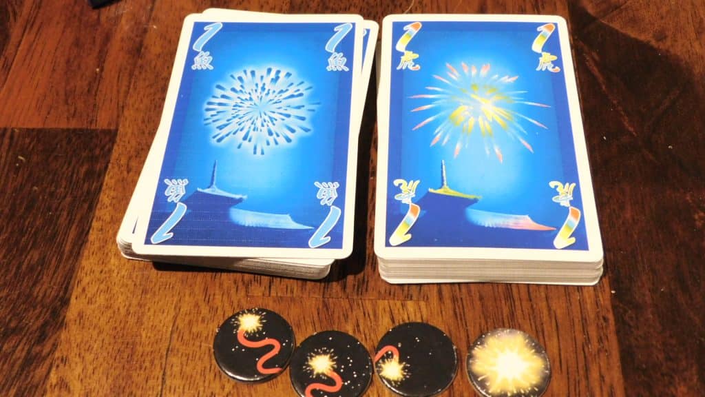 Some cards and tokens in Hanabi.