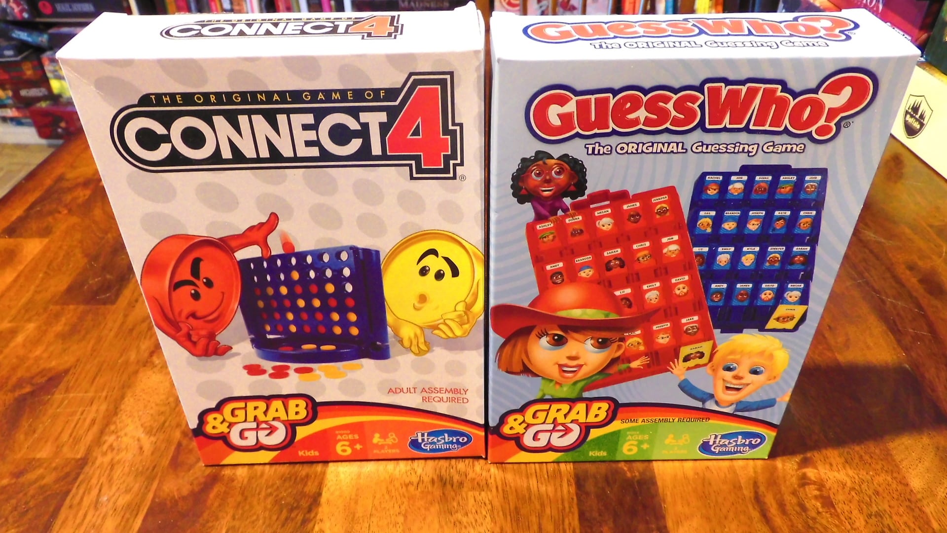 The Connect 4 Grab & Go and Guess Who? Grab & Go boxes beside each other on a table.