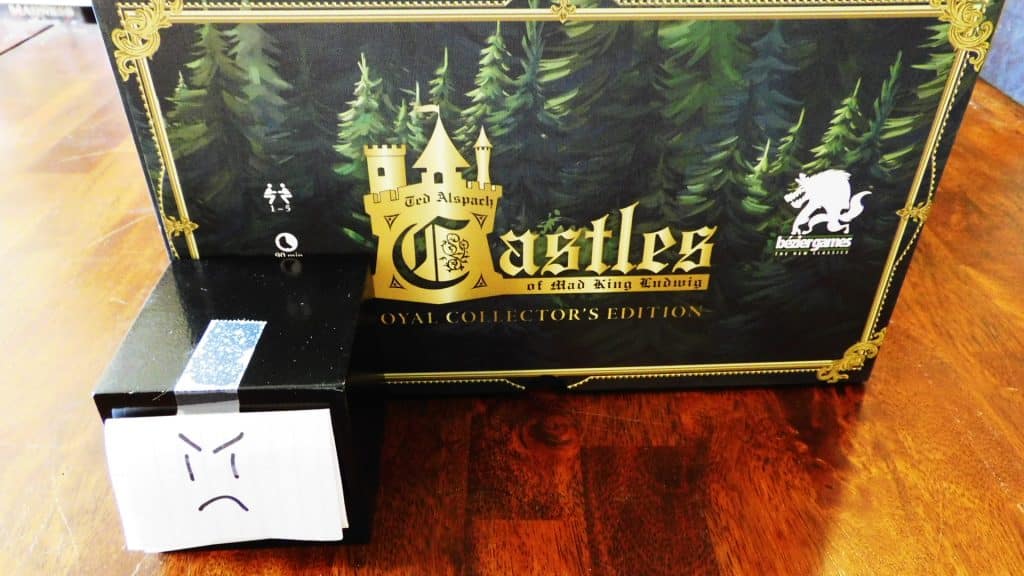 A closeup of Alpha Gamer Al and a side of The Castles Of Mad King Ludwig Royal Collector's Edition.