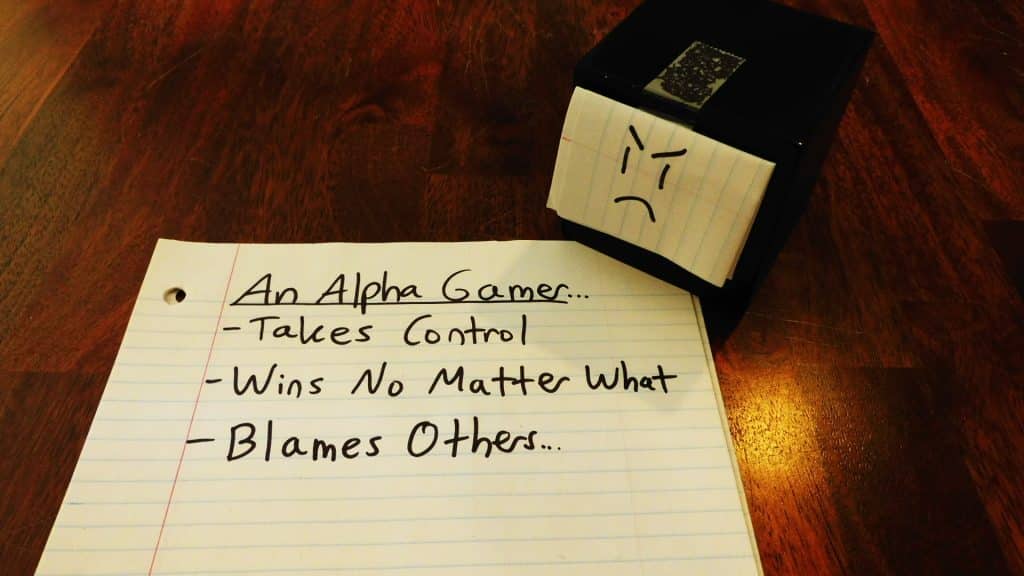 Alpha Gamer Al sitting on a piece of paper listing some things alpha gamers do.