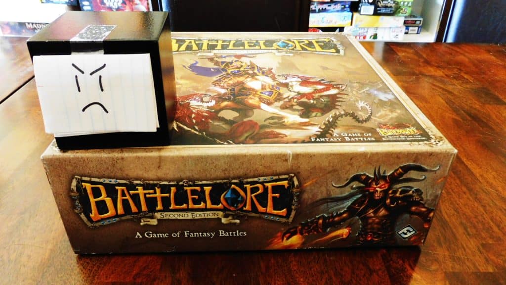 Alpha Gamer Al sitting on top of the Battlelore 2nd Edition board game box.
