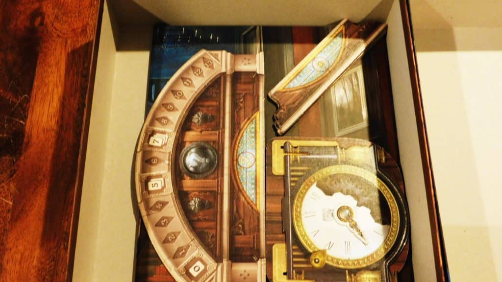 Some boards being placed in the box for Mysterium.