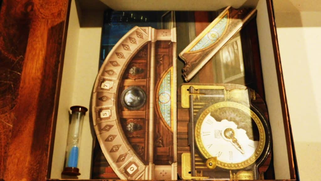 The timer being placed in Mysterium's game box.