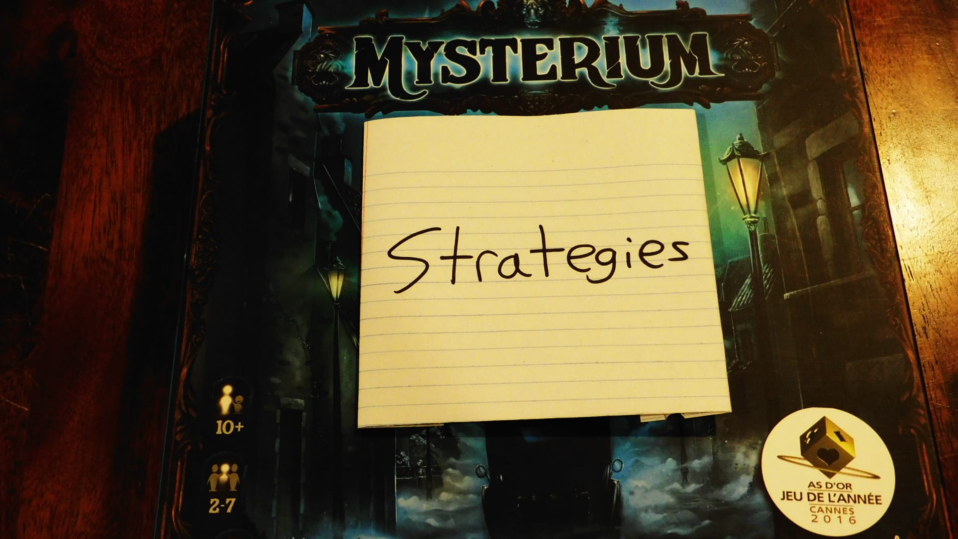 Mysterium game box with a piece of paper on it saying "Strategies."