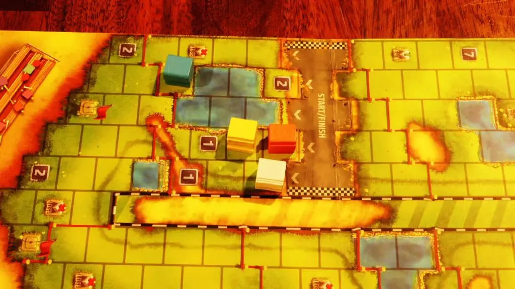 The Cubitos board with some pieces having crossed the finish line.